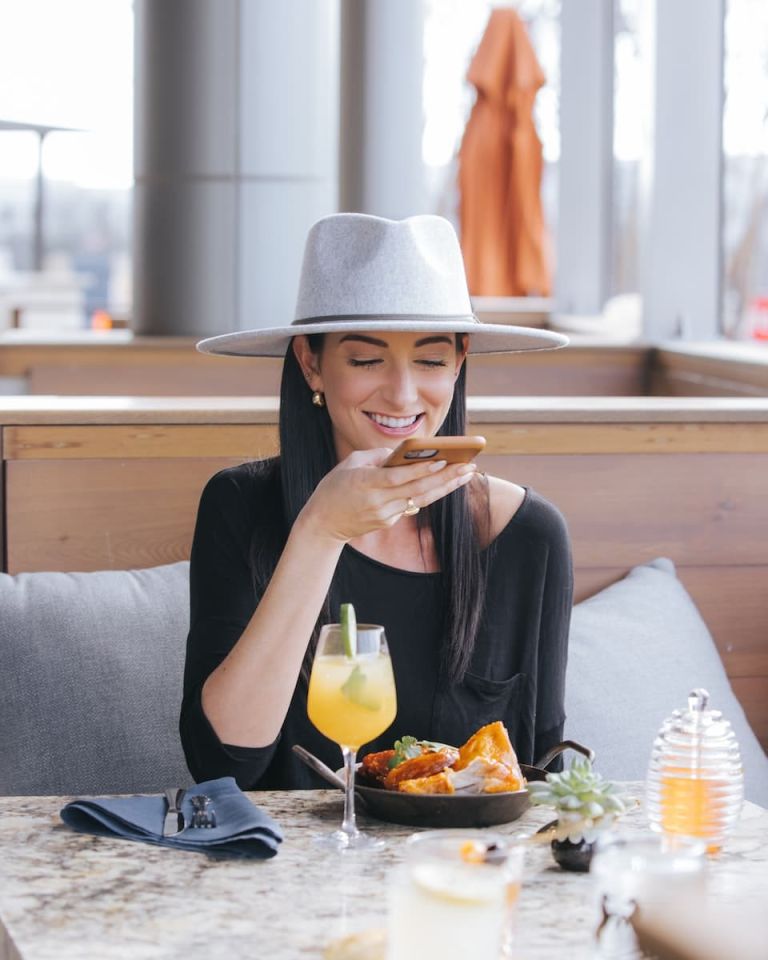 a woman sitting at a table with a plate of food