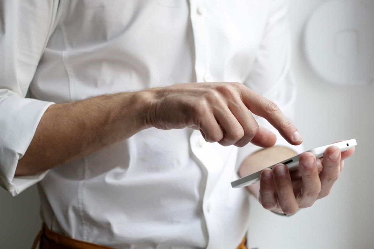 person holding white Android smartphone in white shirt